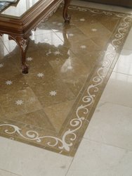 suelo personalizado marmol mares con incrustaciones de cenefa en crema marfil